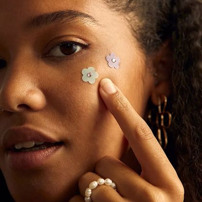 woman wearing some of the acne patches from the article
