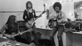 Thin Lizzy, rehearsing backstage in a dressing room at the Roundhouse, London, 3rd November 1974. Left to right: guitarist Scott Gorham, guitarist Brian Robertson and bassist/singer Phil Lynott (1949 - 1986)