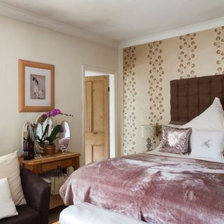 bedroom with cream wall and cosy blanket on bed