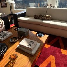 a photo of a wood coffee table with books