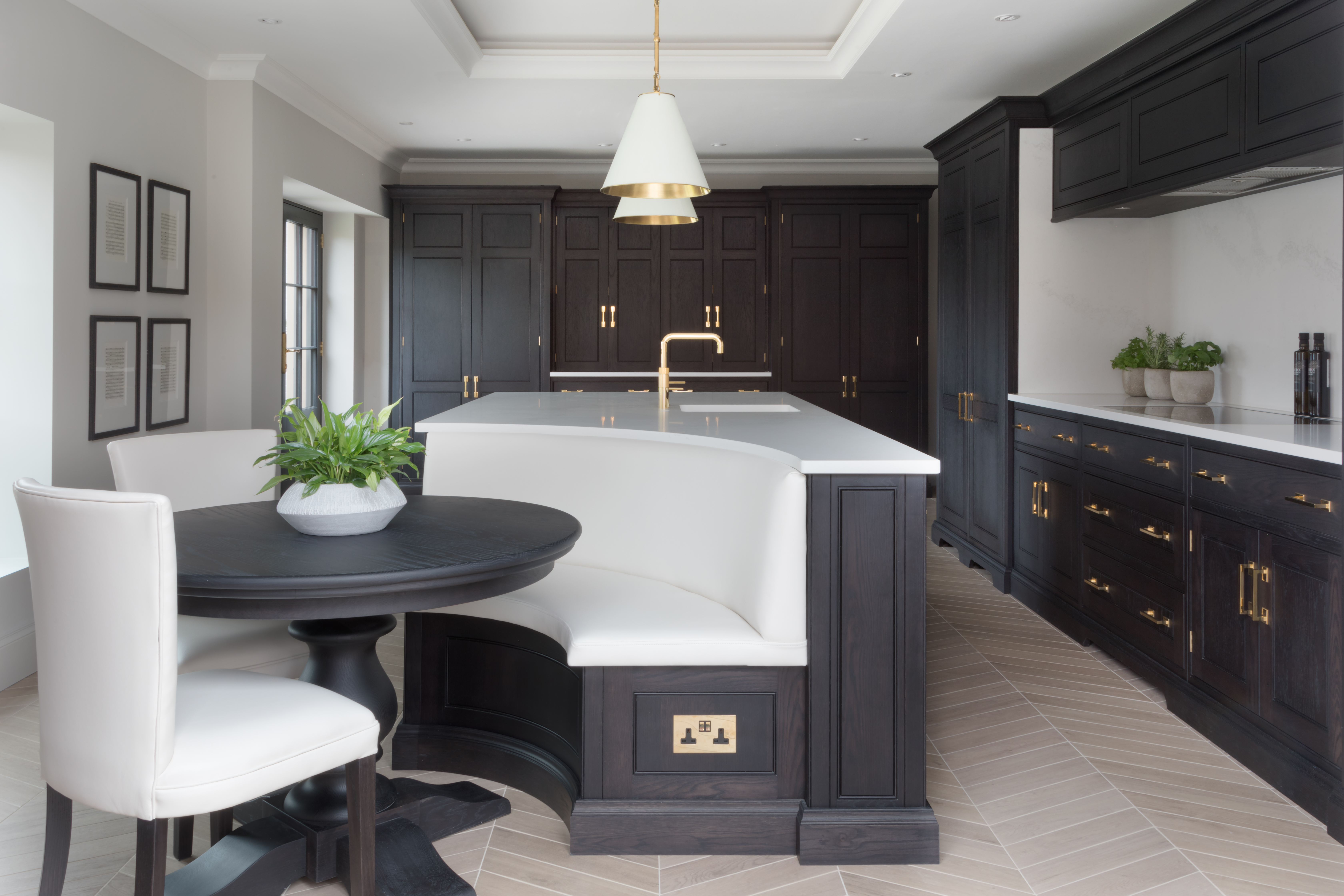 A kitchen island with a seating extension, with a socket on the seating