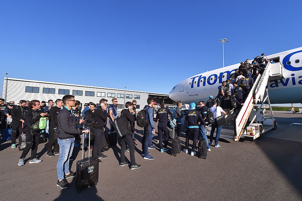 Teams line up to get on the charter plane that will take them to Italy.