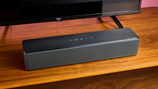 Ultimea Poseidon D50 soundbar on wooden surface