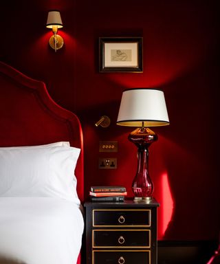 Red walls and bedframe, red glass lamp