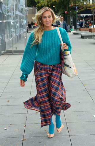 Sarah Jessica Parker matching her teal sweater to her tights in New York City