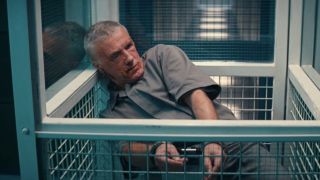 Christoph Waltz slumped over in his cell, presumably dead, in No Time To Die.