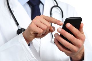 a doctor texts on a smartphone