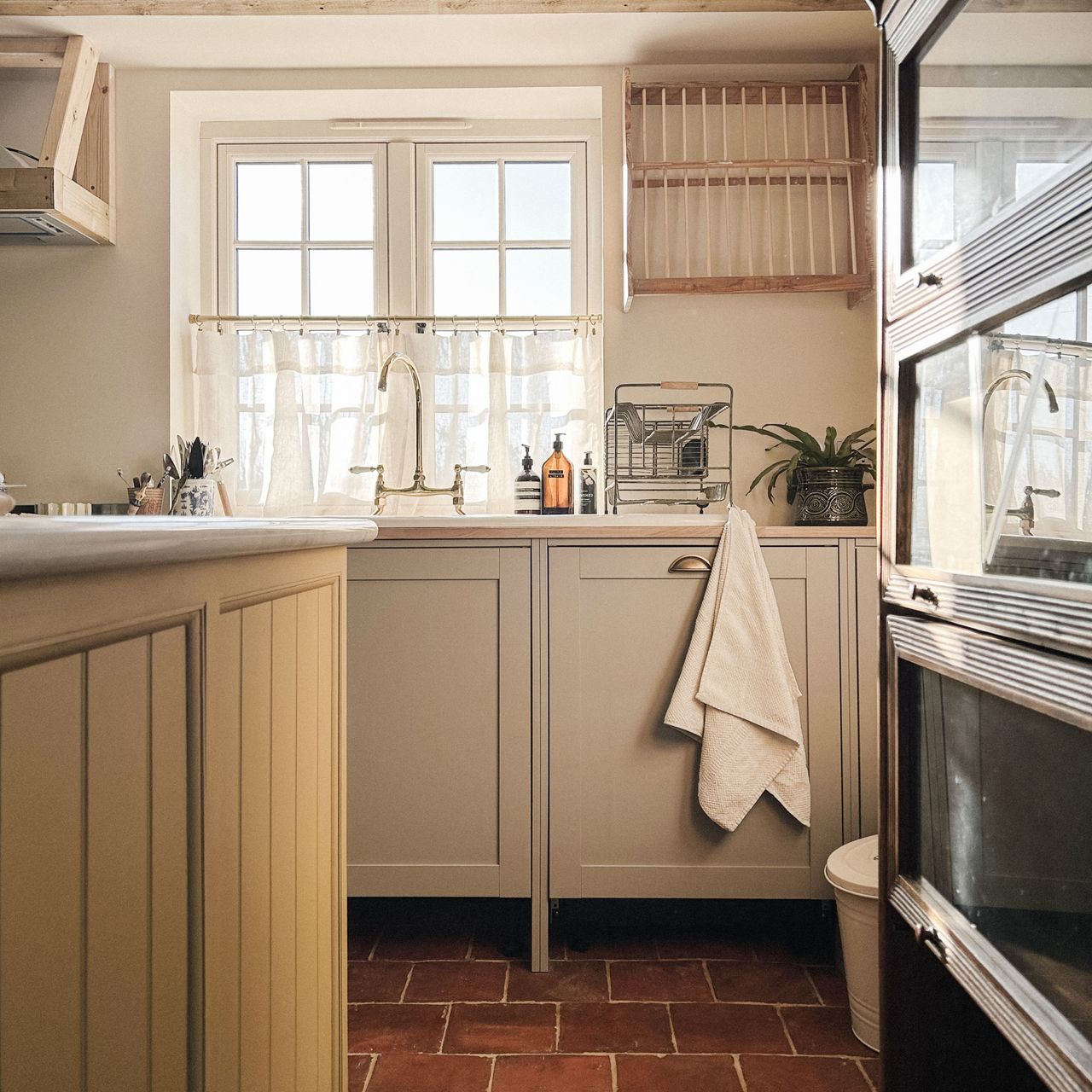 country kitchen with yellow island and grey cabinets