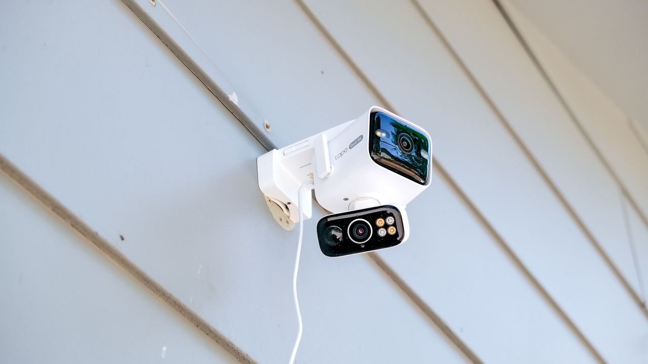 TP-Link Tapo C675D security camera mounted to the side of a house