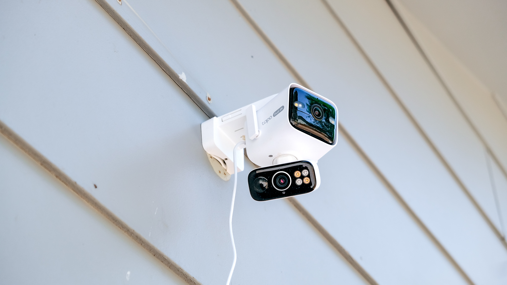 TP-Link Tapo C675D security camera mounted to the side of a house