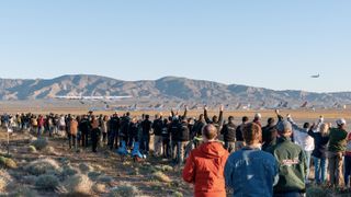 An audience cheers the first, historic flight of Stratolaunch.
