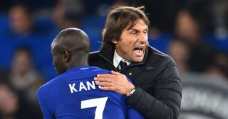 Tottenham Hotspur manager Antonio Conte celebrates on the pitch with Chelsea's French midfielder N'Golo Kante (L) after the English Premier League football match between Chelsea and Manchester United at Stamford Bridge in London on November 5, 2017. Chelsea won the game 1-0.