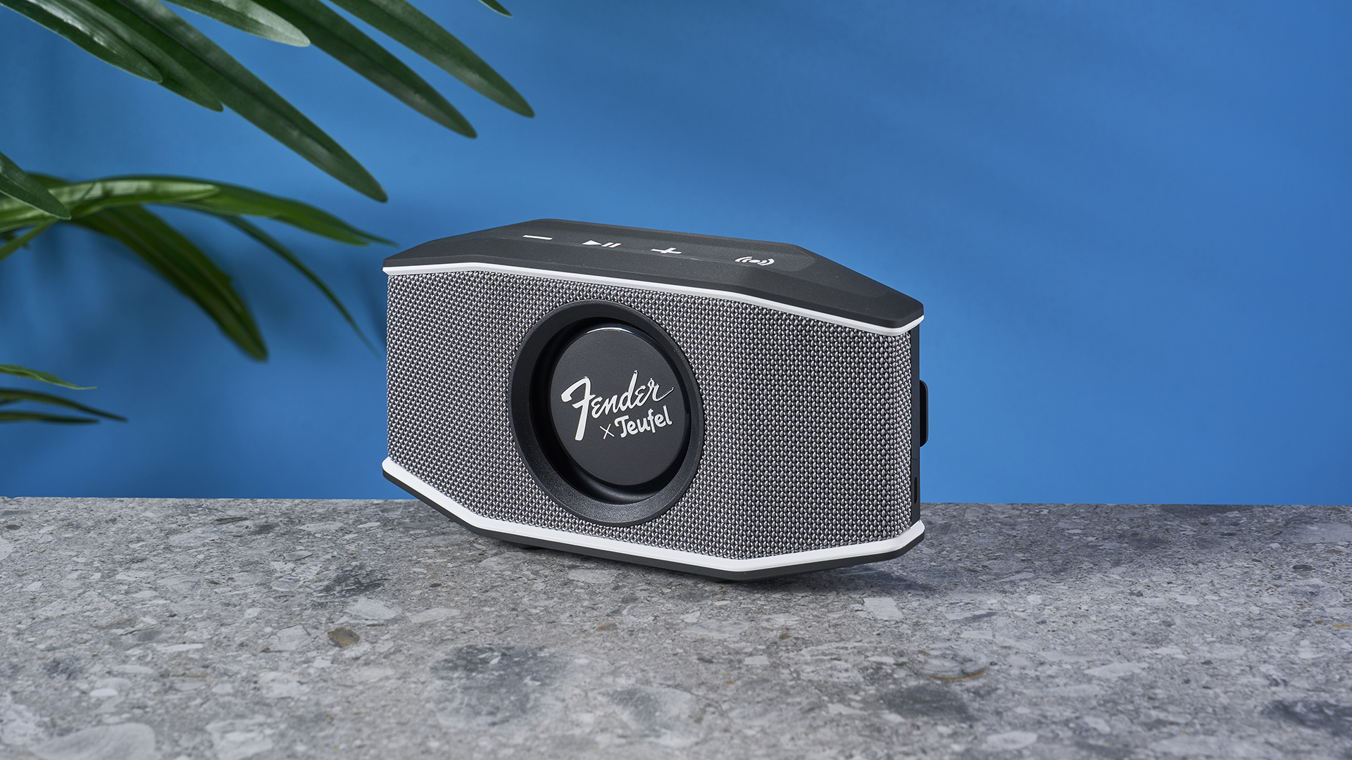 a retro-inspired bluetooth speaker 8 inches long and 4 inches tall with a circular woofer in the center branded with Fender and Teufel