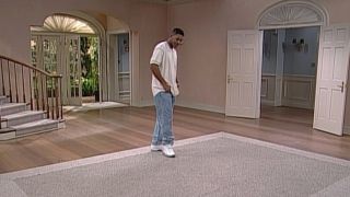 Will Smith stands somberly in the middle of an empty living room in The Fresh Prince of Bel-Air series finale.