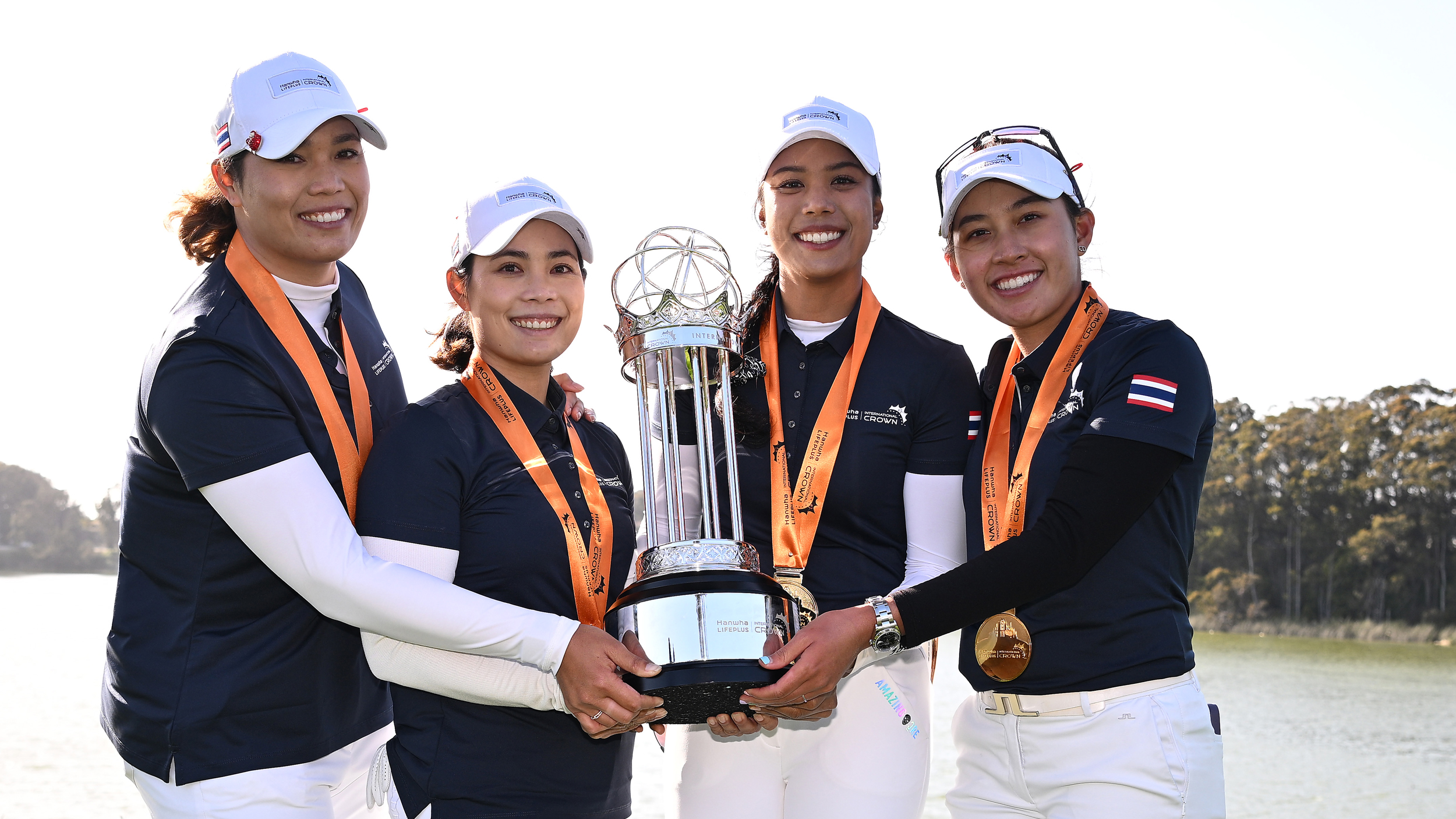 Team Thailand pose with the International Crown trophy 