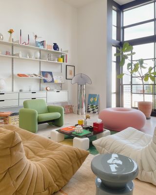 a living room with a doughnut shaped pouf
