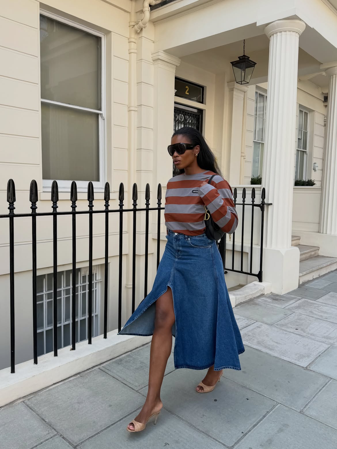@nlmarilyn wears striped long-sleeve top and denim midi skirt