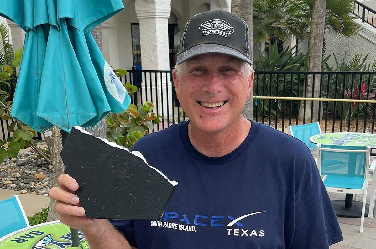 Joe Tegtmeyer holds up a possible heat shield tile from the first test flight of SpaceX&#039;s Starship and Super Heavy launch vehicle on April 20, 2023. The fragment was found on South Padre Island Beach, about seven miles from where Starship launched.