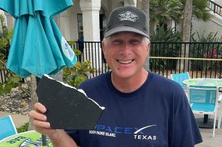 Joe Tegtmeyer holds up a possible heat shield tile from the first test flight of SpaceX's Starship and Super Heavy launch vehicle on April 20, 2023. The fragment was found on South Padre Island Beach, about seven miles from where Starship launched.