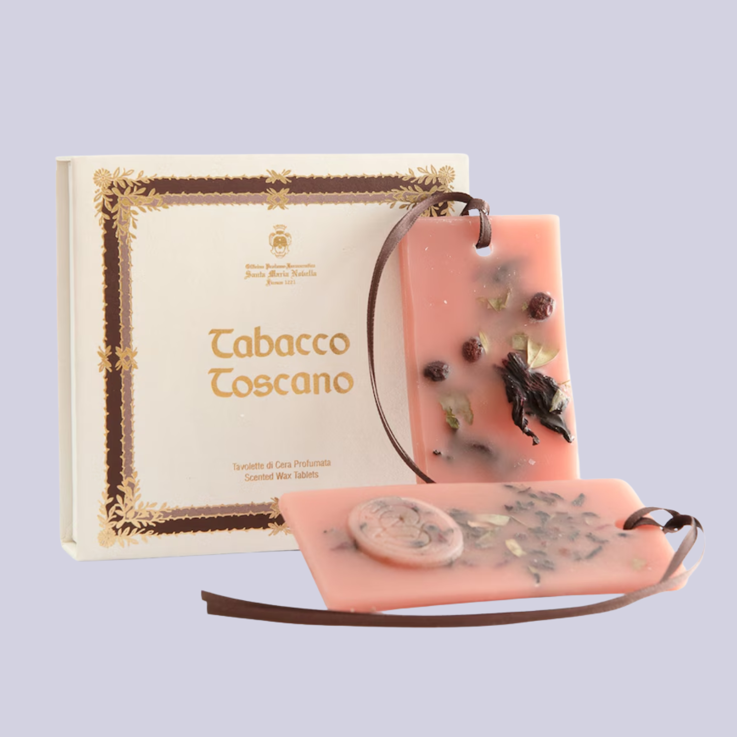 A pink wax tablet with a ribbon