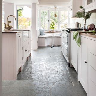 white kitchen with tiled flooring and white cabinets