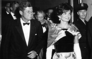 President Kennedy and First Lady Jacqueline Kennedy depart the National Theater Sept. 25, 1962 in Washington, DC. 