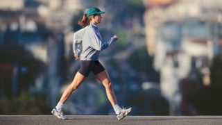 a woman power walking through the street