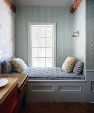Blue and white wallpaper and mattress, white window frame