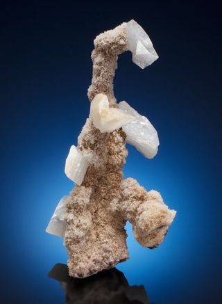 The minerals are common, but the configuration of this 6-inch-tall specimen makes it one-of-a-kind. The unusual form, which came together in a bubble in a lava flow, inspired the nickname Godzilla as a Hockey Goalie. 