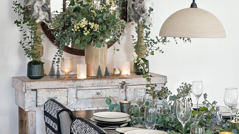 White dining room with foliage and pendant light