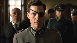 Terrence Stamp standing behind Tom Cruise in uniform in Valkyrie.