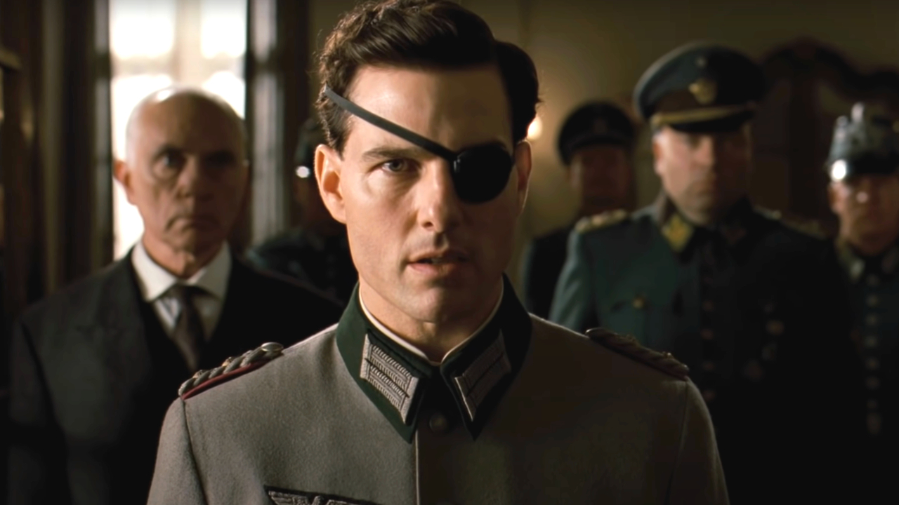 Terrence Stamp standing behind Tom Cruise in uniform in Valkyrie.