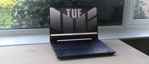 Asus Tuf Gaming F15 laptop on a wooden surface