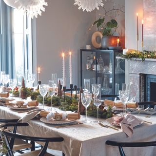 Dining room with Christmas tablescape in neutral colours.