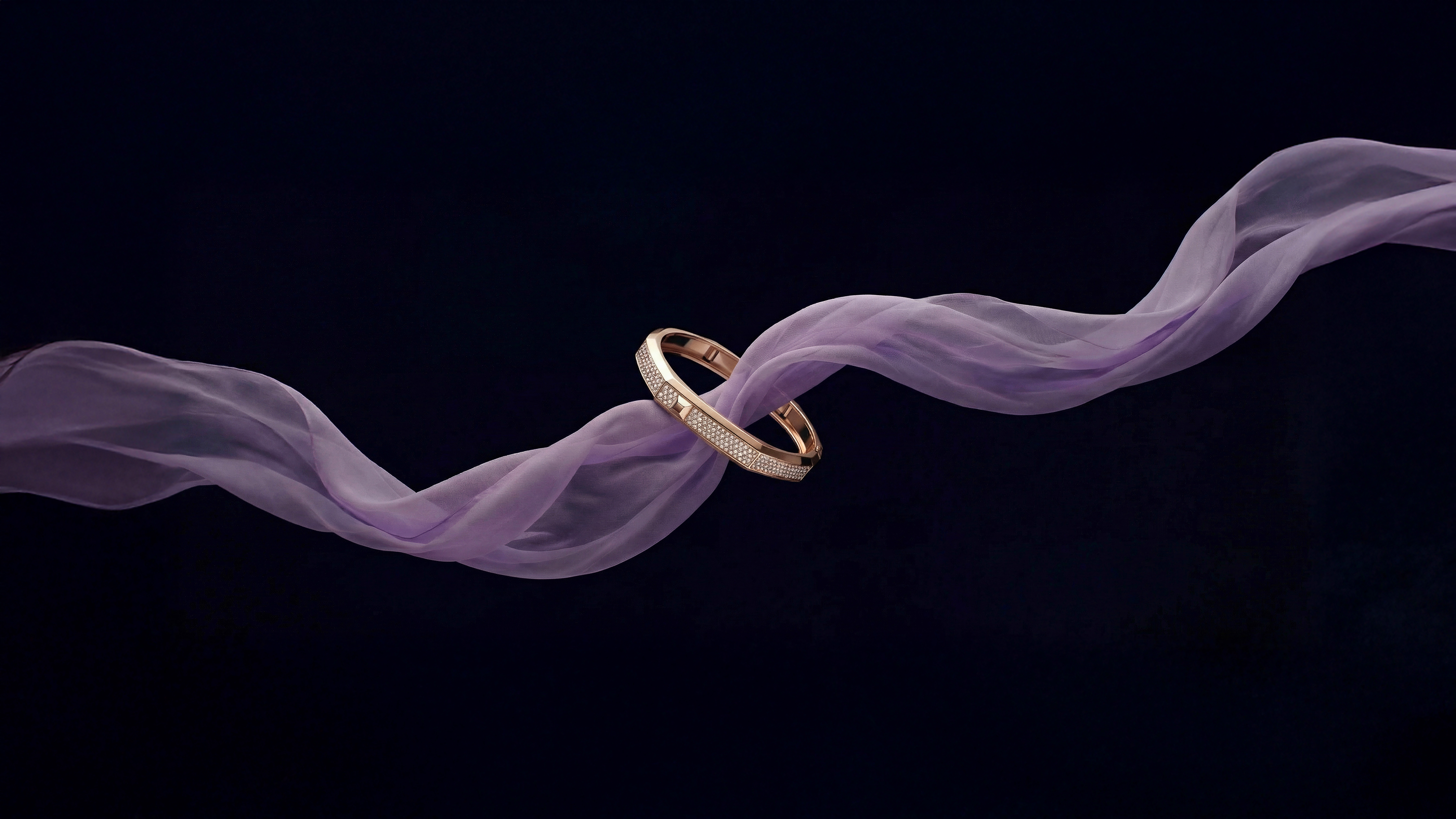 From Messika Moderniste jewellery collection: gold bracelet on purple scarf