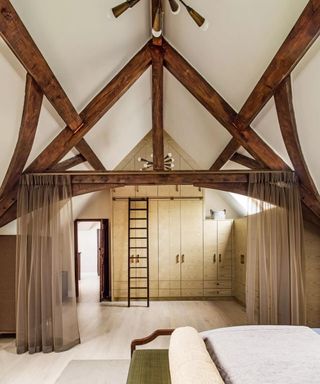 Bedroom with large rafters and linen room divider