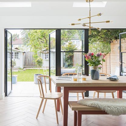 Navy kitchen with wooden table and glass windows