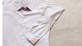 White shirt with oil stains on sleeve