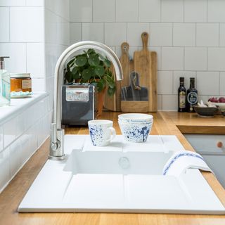 kitchen with white sink and wooden counter top