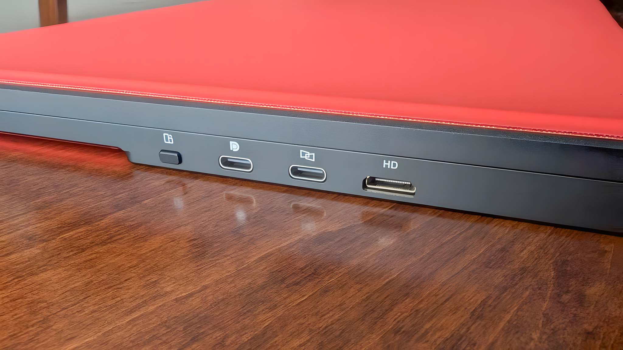 Close up of the JSAUX FlipGo Pro 16's mode button, two USB-C display ports, and mini HDMI port.