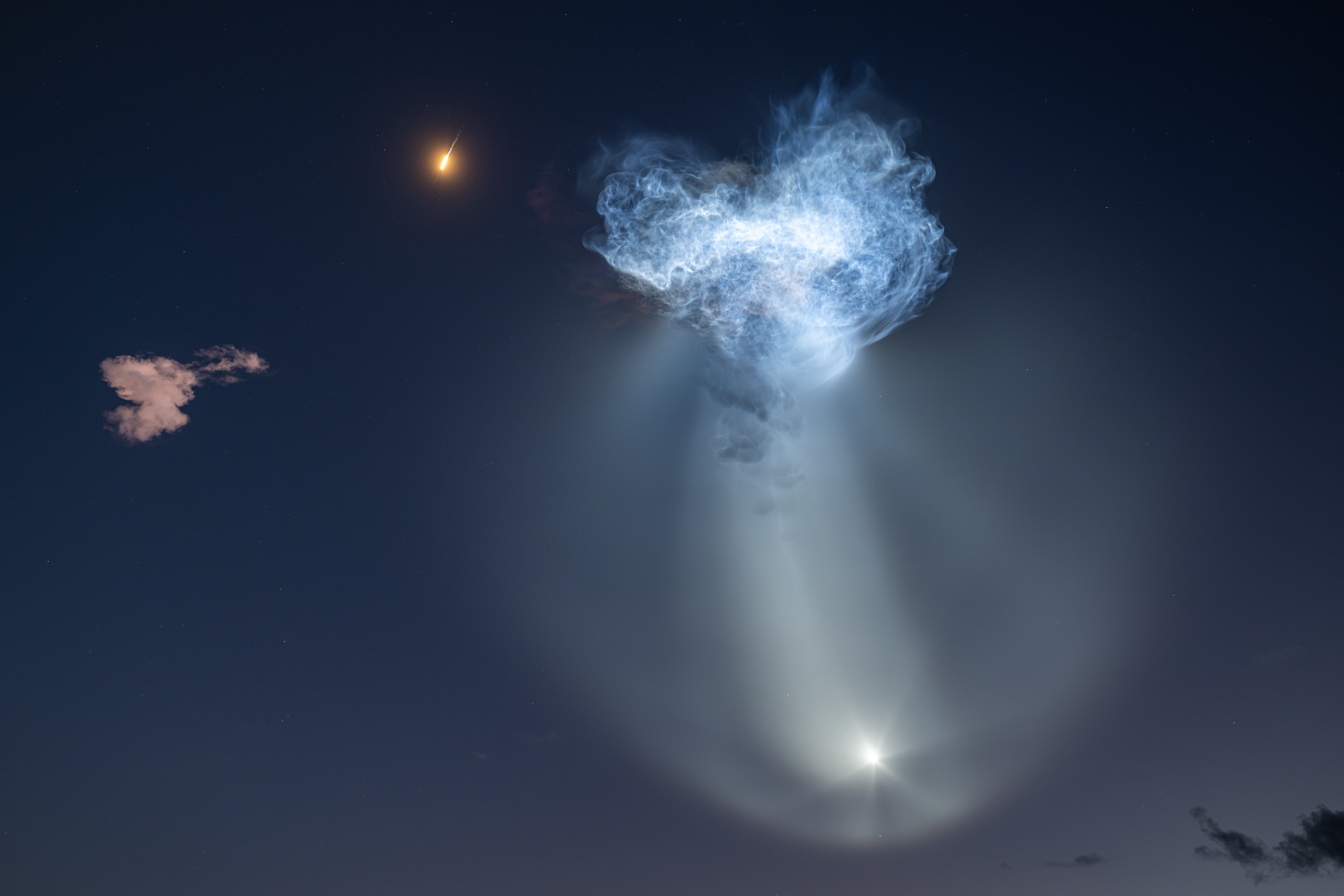 Sunlight hitting exhaust plumes from a SpaceX rocket creates an unusual shape in the sky