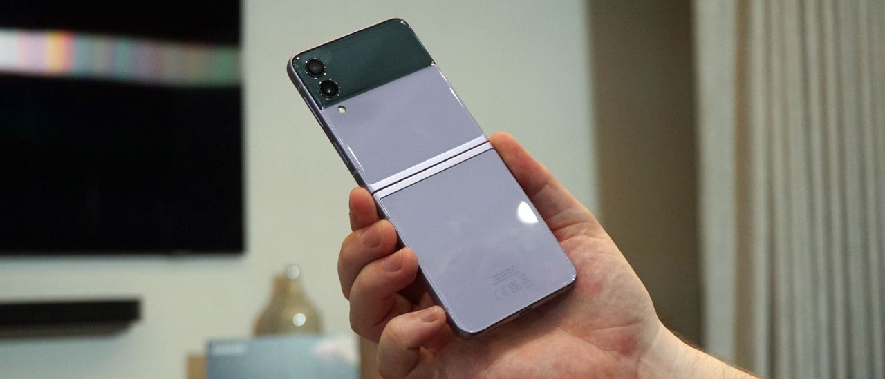 A Samsung Galaxy Z Flip 3 from the back, in someone's hand