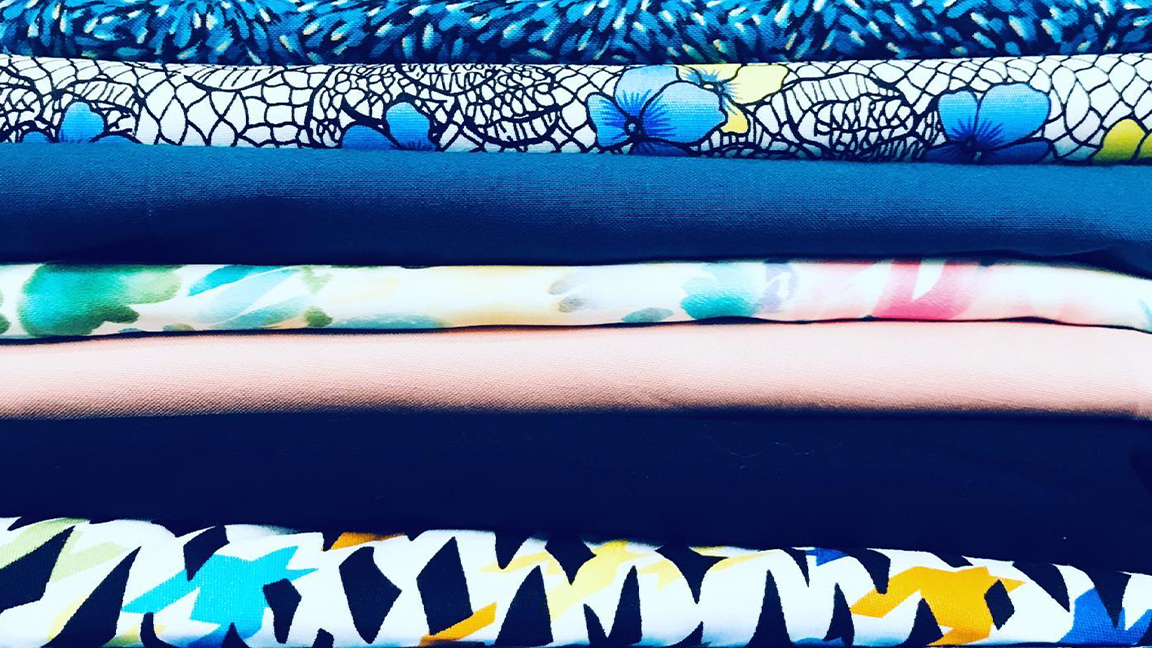 How to start sewing; a stack of colourful fabrics