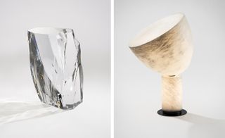 A glacier shaped scupture made of acrylic and a table lamp with a metal base