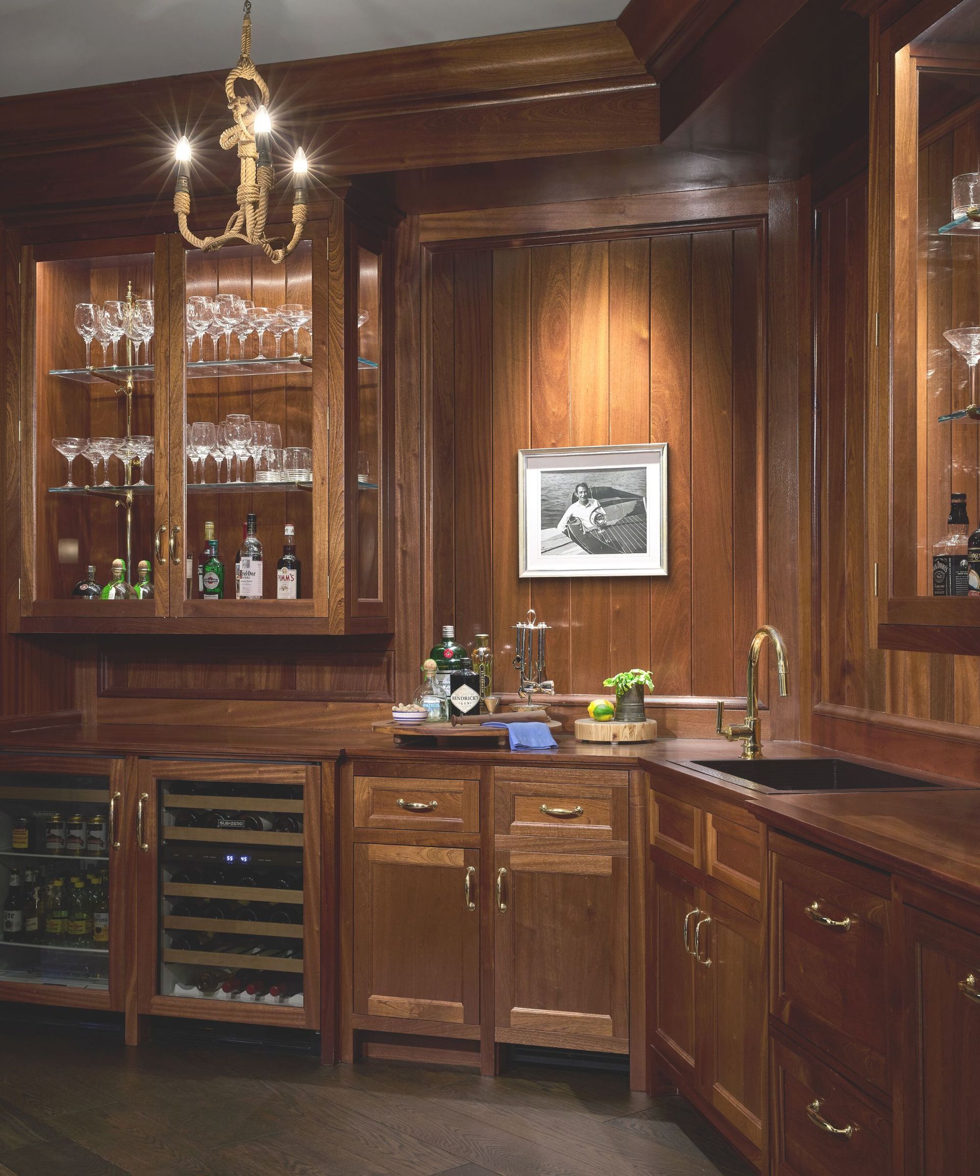 home bar with dark wood walls