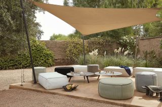 outdoor seating ideas: covered seating with outdoor rugs and pouffes