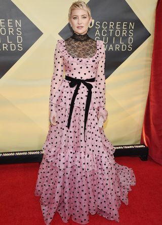 Kate Hudson on the red carpet in a pink and black dress