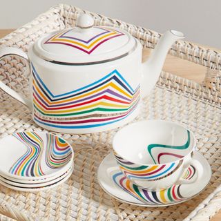 White tea set, mugs, saucers and teapot with multicolored stripe design