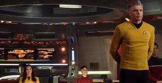 a man with gray hair in a yellow starfleet uniform