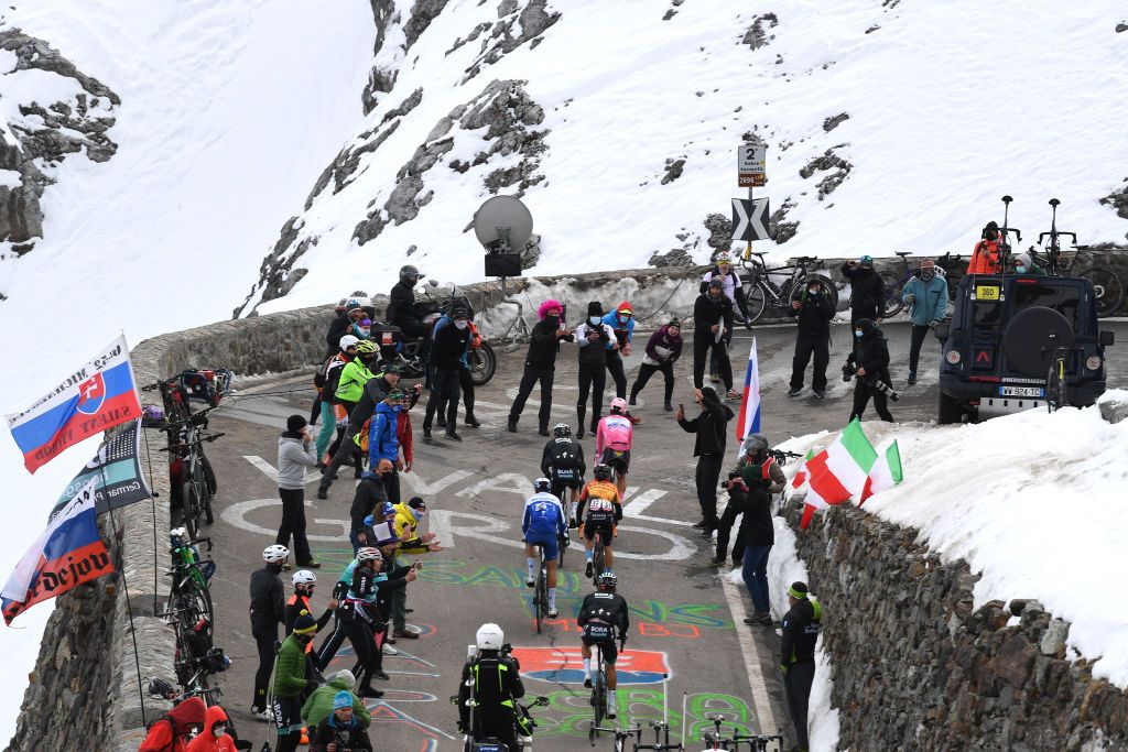 LAGHI DI CANCANO ITALY OCTOBER 22 Joao Almeida of Portugal and Team Deceuninck QuickStep Pink Leader Jersey Rafal Majka of Poland and Team Bora Hansgrohe Hermann Pernsteiner of Austria and Team Bahrain Mclaren Fausto Masnada of Italy and Team Deceuninck QuickStep Passo dello Stelvio Stilfserjoch 2758m Grenadiers Car Team INEOS Grenadiers Snow Fans Public Peloton during the 103rd Giro dItalia 2020 Stage 18 a 207km stage from Pinzolo to Laghi di Cancano Parco Nazionale dello Stelvio 1945m girodiitalia Giro on October 22 2020 in Laghi di Cancano Italy Photo by Tim de WaeleGetty Images